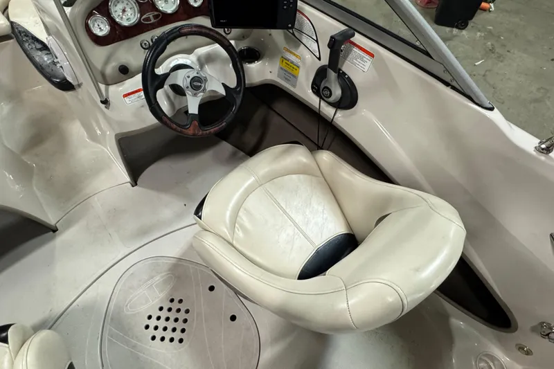 Slide: The Image of Interior of a 2013 Tahoe Q5i boat featuring steering wheel and dashboard controls. - 4