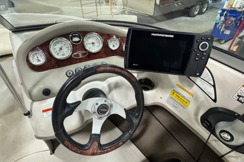 Slide: The Image of Steering console of 2013 Tahoe Q5i boat with gauges and Humminbird Helix 7 display. - 5
