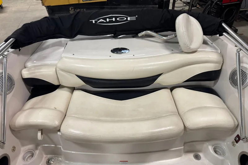 Slide: The Image of 2013 Tahoe Q5i boat interior with white cushioned seating and Tahoe branding. - 8