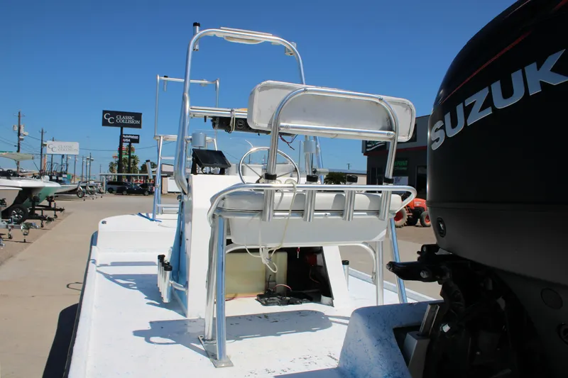 Slide: The Image of 2017 CCB Phoenix boat with Suzuki engine, parked outdoors under clear blue sky. - 12
