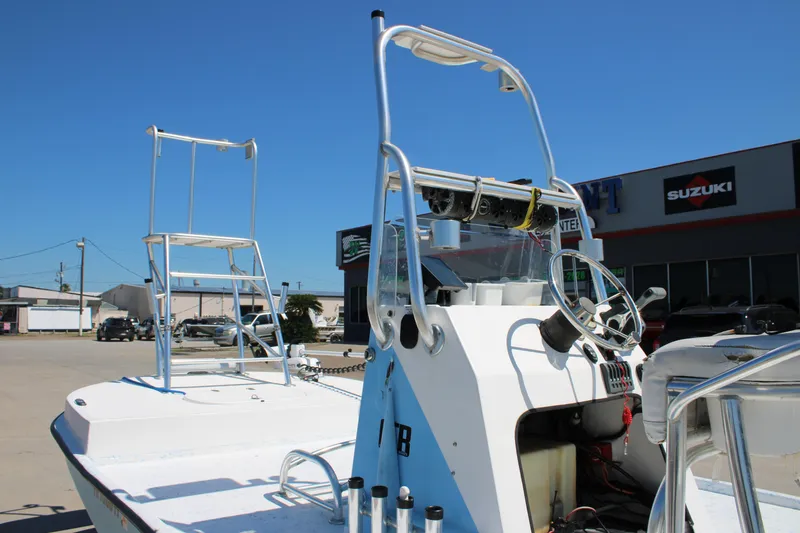 Slide: The Image of 2017 CCB Phoenix boat with steering console, parked near Suzuki dealership. - 13