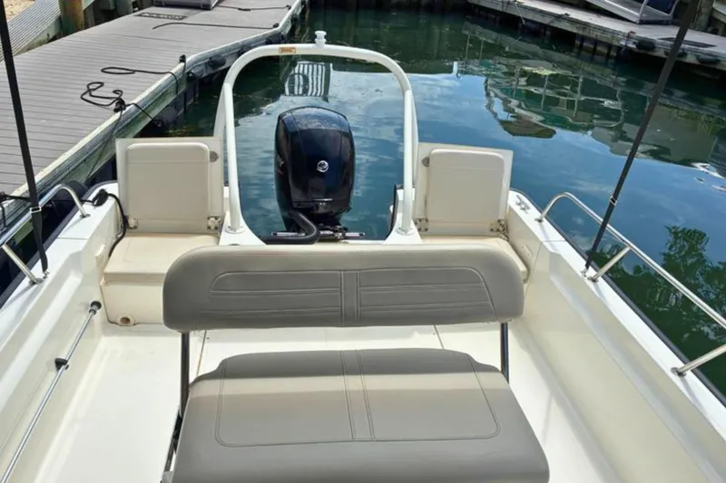 Slide: The Image of 2020 Boston Whaler 210 Montauk boat interior with seating and outboard motor. - 11