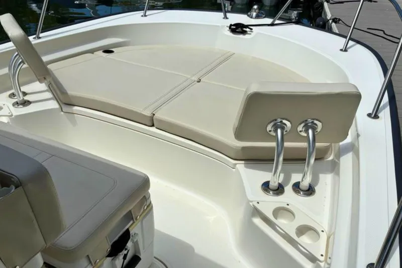 Slide: The Image of 2020 Boston Whaler 210 Montauk boat interior with cushioned seating and stainless steel fixtures. - 17
