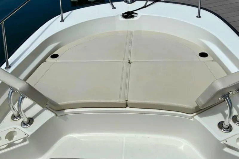 Slide: The Image of 2020 Boston Whaler 210 Montauk boat seating area with cushioned seats and stainless steel rails. - 18