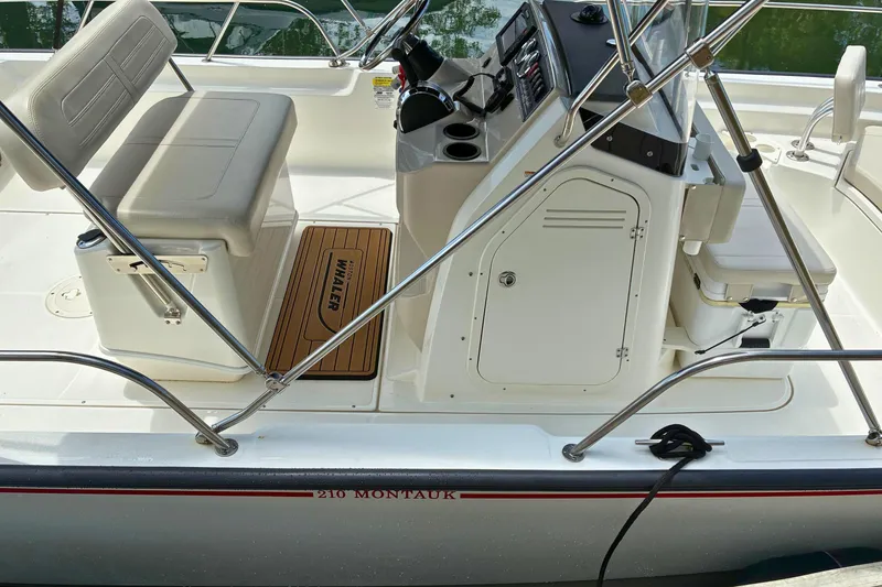 Slide: The Image of 2020 Boston Whaler 210 Montauk boat interior with seating and control panel. - 21