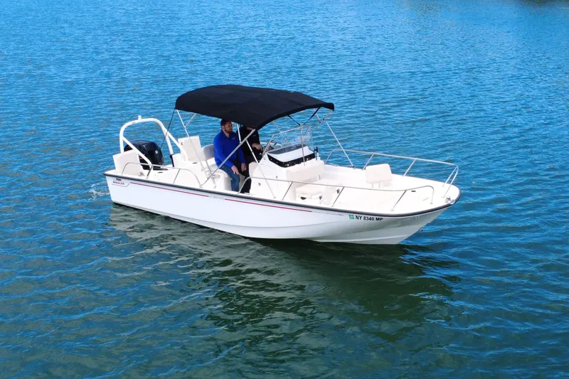 Slide: The Image of 2020 Boston Whaler 210 Montauk boat on calm blue water. - 4