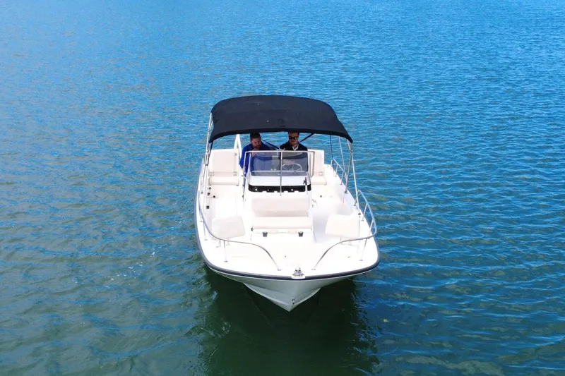 Slide: The Image of 2020 Boston Whaler 210 Montauk boat cruising on calm blue water. - 6