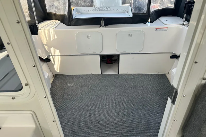 Slide: The Image of Interior of a 2018 C-Dory 23' Venture boat with carpeted flooring. - 10