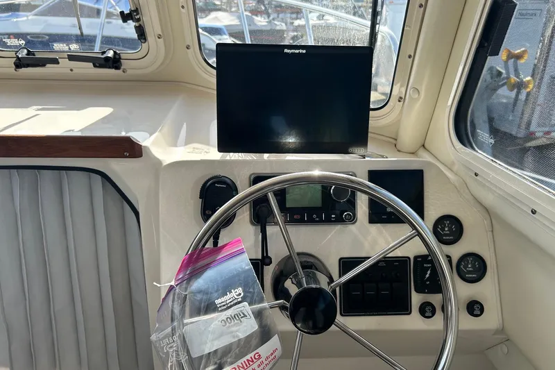 Slide: The Image of Helm of 2018 C-Dory 23' Venture boat with steering wheel and navigation equipment. - 13
