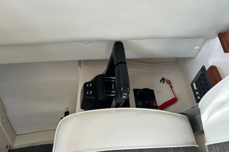 Slide: The Image of Interior controls of a 2018 C-Dory 23' Venture boat, featuring throttle and switches. - 17