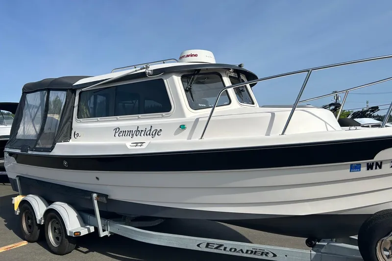 Slide: The Image of 2018 C-Dory 23' Venture boat on trailer, named "Pennybridge," with enclosed cabin. - 3