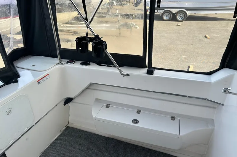 Slide: The Image of Interior of a 2018 C-Dory 23' Venture boat with seating and storage. - 6