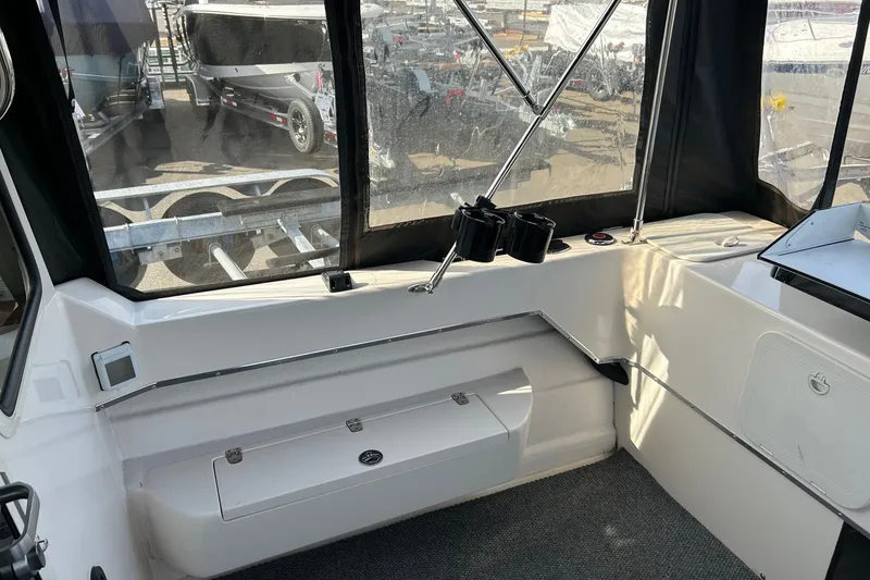Slide: The Image of Interior view of a 2018 C-Dory 23' Venture boat, showcasing seating and storage. - 7