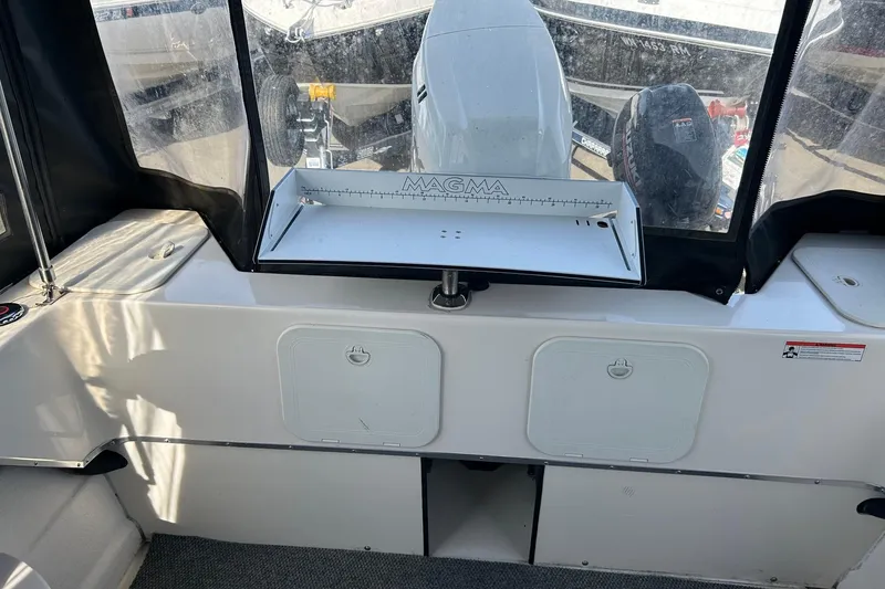 Slide: The Image of 2018 C-Dory 23' Venture boat interior with Magma grill and storage compartments. - 8