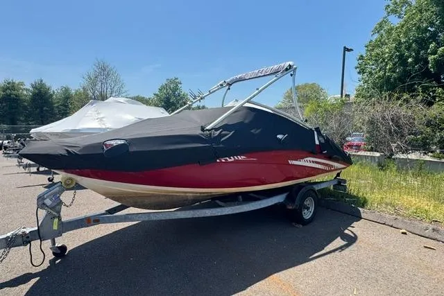 Slide: The Image of 2014 Yamaha AR192 boat on trailer, covered, parked outdoors. - 2