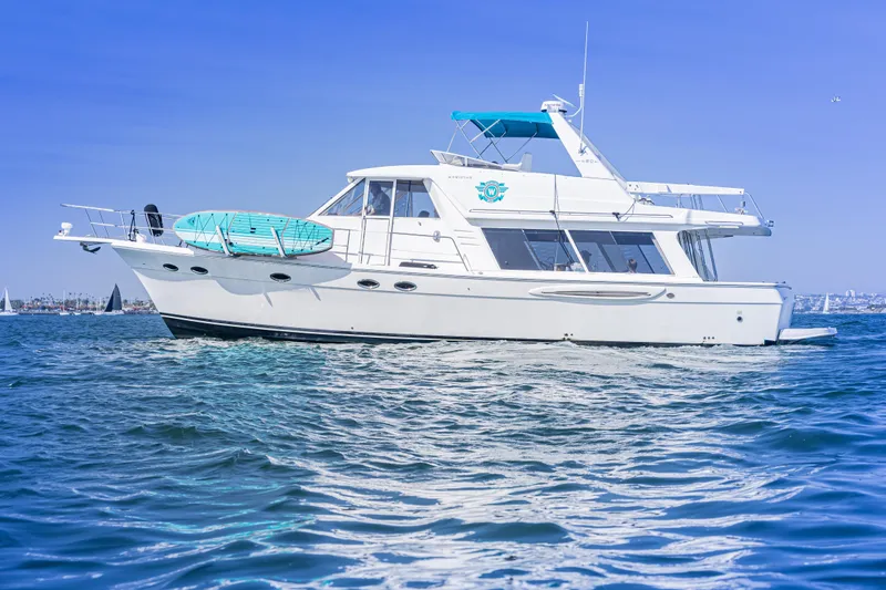 The Image of 2004 Meridian 490 Pilothouse yacht cruising on clear blue waters. - 0