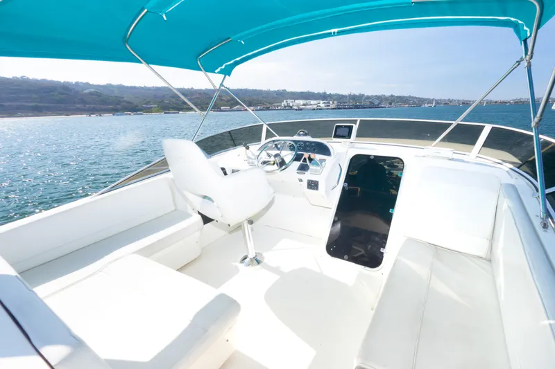 Slide: The Image of 2004 Meridian 490 Pilothouse boat interior with blue canopy on open water. - 11