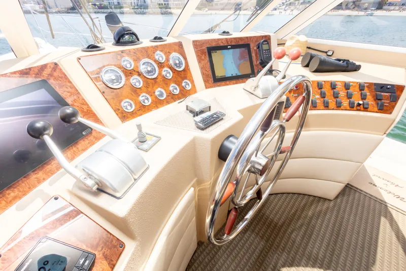 Slide: The Image of Pilothouse of 2004 Meridian 490, featuring steering wheel, controls, and navigation instruments. - 15
