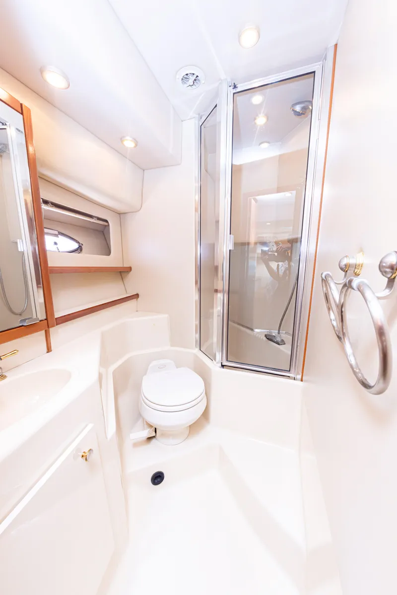 Slide: The Image of 2004 Meridian 490 Pilothouse bathroom with shower, toilet, and mirror. - 18