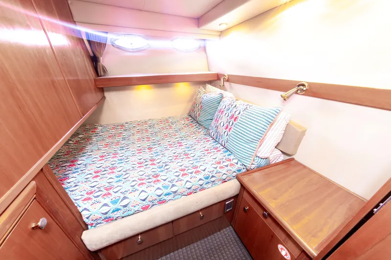 Slide: The Image of Cozy cabin interior of 2004 Meridian 490 Pilothouse with colorful bedding and wooden furnishings. - 22