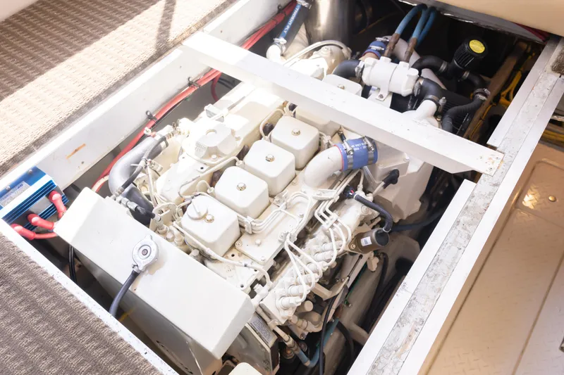 Slide: The Image of Engine compartment of a 2004 Meridian 490 Pilothouse yacht, showcasing detailed mechanical components. - 23