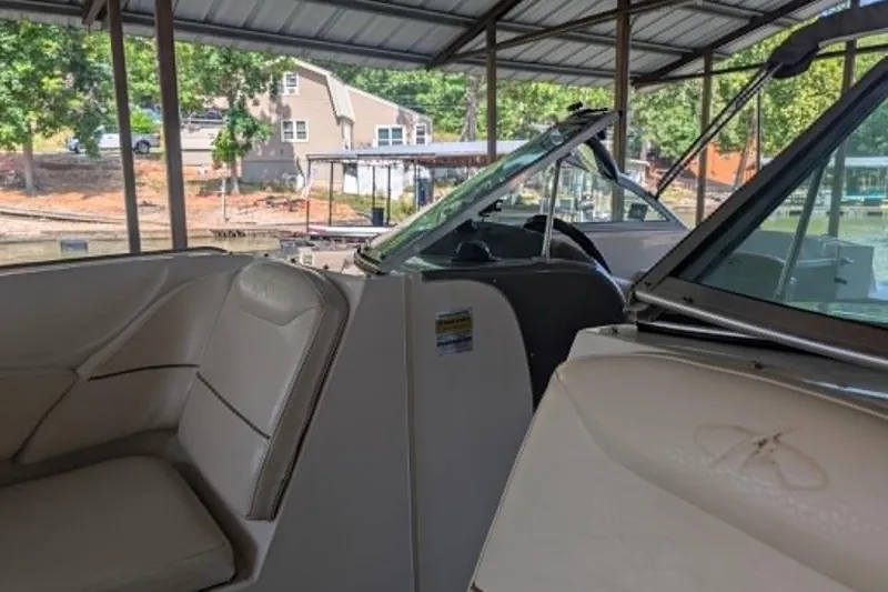 Slide: The Image of Interior view of a 2001 Monterey 248LS Montura Bowrider under a covered dock. - 10