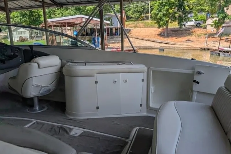 Slide: The Image of Interior of a 2001 Monterey 248LS Montura Bowrider boat at a dock. - 12