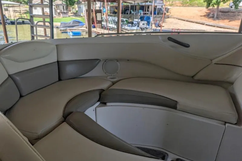 Slide: The Image of Interior seating of a 2001 Monterey 248LS Montura Bowrider boat, featuring cushioned seats. - 13