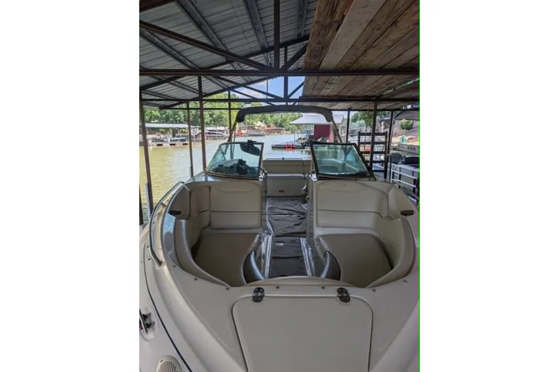 Slide: The Image of 2001 Monterey 248LS Montura Bowrider docked under a covered marina. - 2