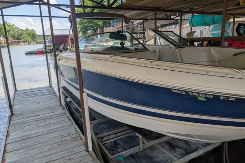 Slide: The Image of 2001 Monterey 248LS Montura Bowrider docked in a marina, blue and white exterior. - 3