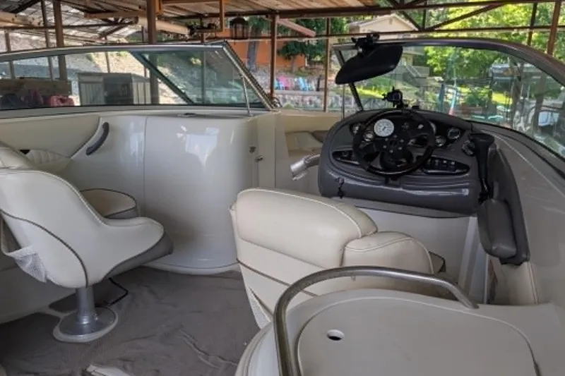 Slide: The Image of Interior of a 2001 Monterey 248LS Montura Bowrider with beige seating and steering console. - 8