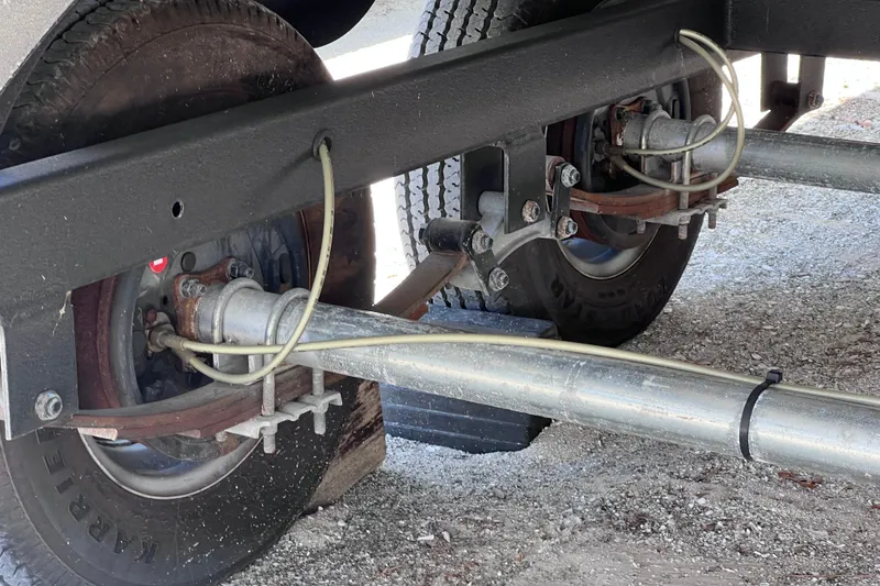 Slide: The Image of Trailer axle and suspension system of 2023 Sun Tracker Fishin' Barge 22 DLX. - 11