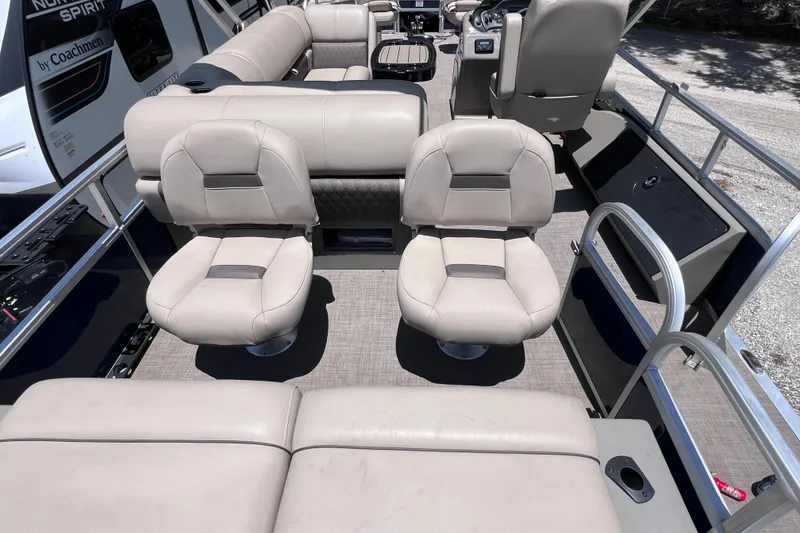 Slide: The Image of 2023 Sun Tracker Fishin' Barge 22 DLX interior with beige seating and spacious layout. - 13