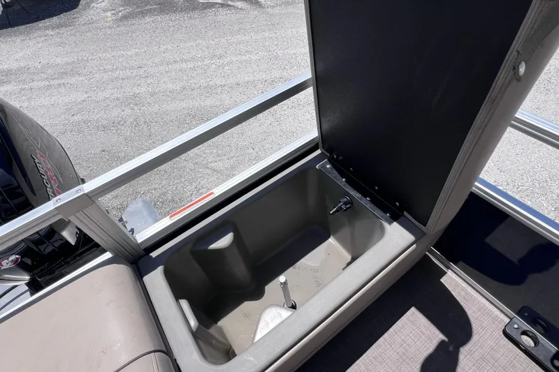 Slide: The Image of Open storage compartment on 2023 Sun Tracker Fishin' Barge 22 DLX boat. - 15