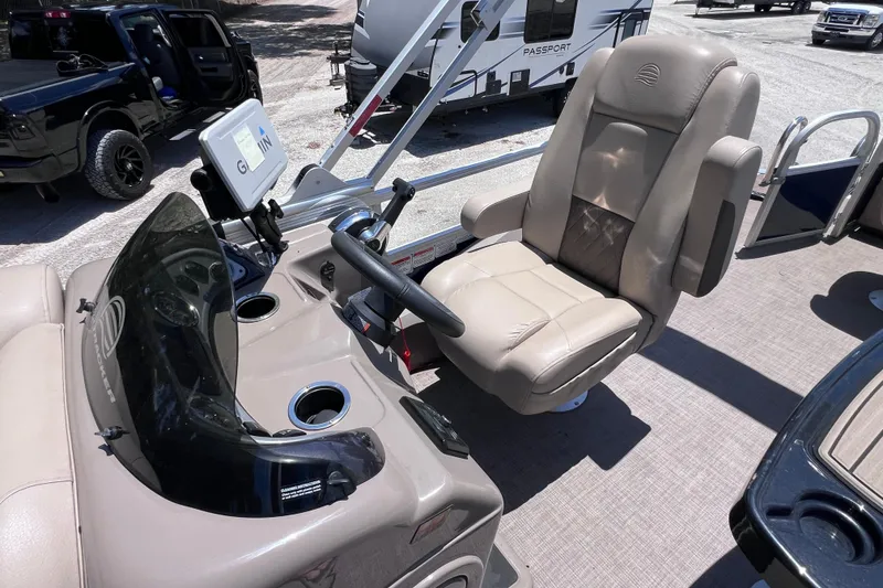 Slide: The Image of 2023 Sun Tracker Fishin' Barge 22 DLX helm with comfortable captain's chair and steering console. - 21