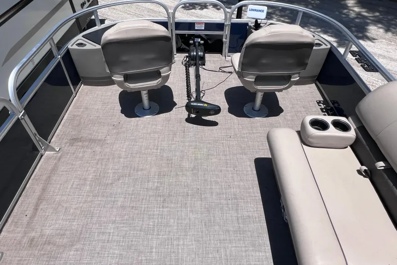 Slide: The Image of 2023 Sun Tracker Fishin' Barge 22 DLX interior with seating and fishing equipment. - 28