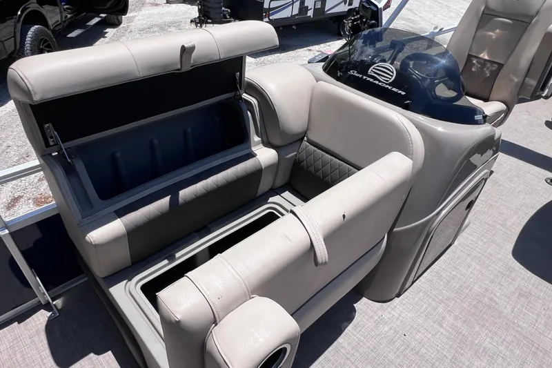 Slide: The Image of 2023 Sun Tracker Fishin' Barge 22 DLX interior with open storage compartment. - 29
