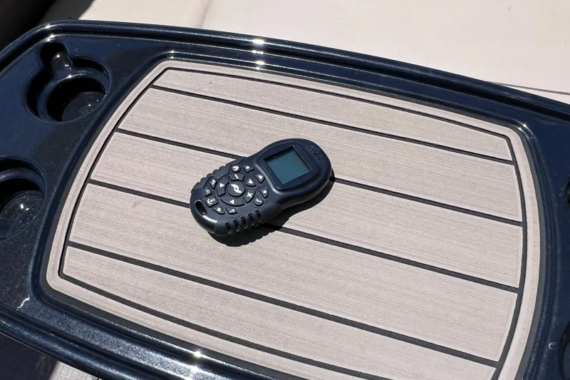 Slide: The Image of Remote control on Sun Tracker Fishin' Barge 22 DLX boat table, 2023 model. - 32