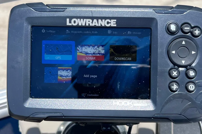 Slide: The Image of Lowrance Hook Reveal fish finder displaying GPS, sonar, and downscan options on a Sun Tracker boat. - 37