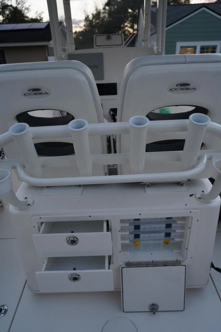 Slide: The Image of 2022 Cobia 266 boat interior with rod holders and storage compartments. - 13