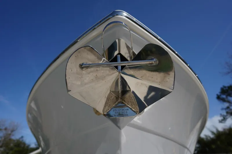 Slide: The Image of Bow view of 2022 Cobia 266 boat with shiny anchor against blue sky. - 26