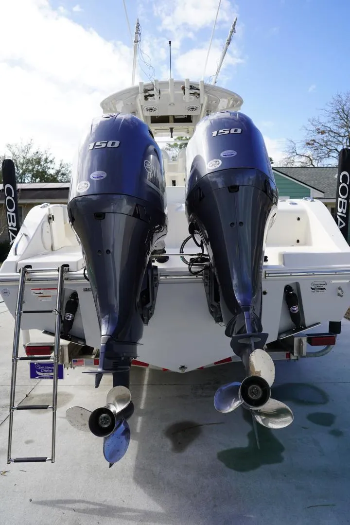 Slide: The Image of 2022 Cobia 266 boat with dual 150 horsepower outboard engines, rear view. - 28