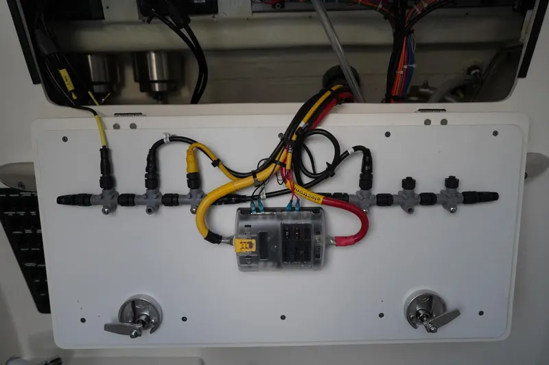 Slide: The Image of Electrical wiring setup on a 2022 Cobia 266 boat, featuring organized cables and connectors. - 36
