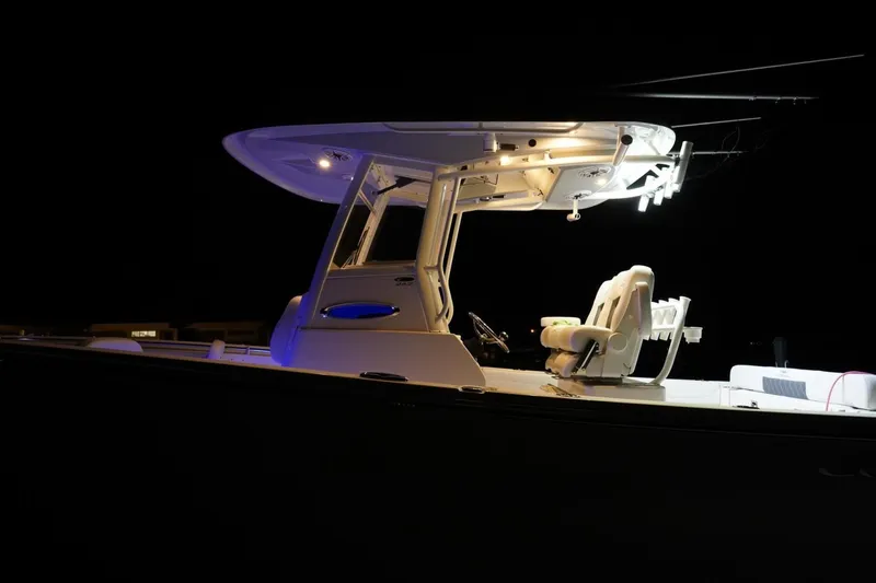 Slide: The Image of 2022 Cobia 266 boat illuminated at night, showcasing sleek design and modern features. - 46