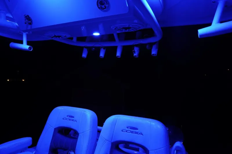 Slide: The Image of 2022 Cobia 266 boat interior with blue LED lighting and branded seats. - 49