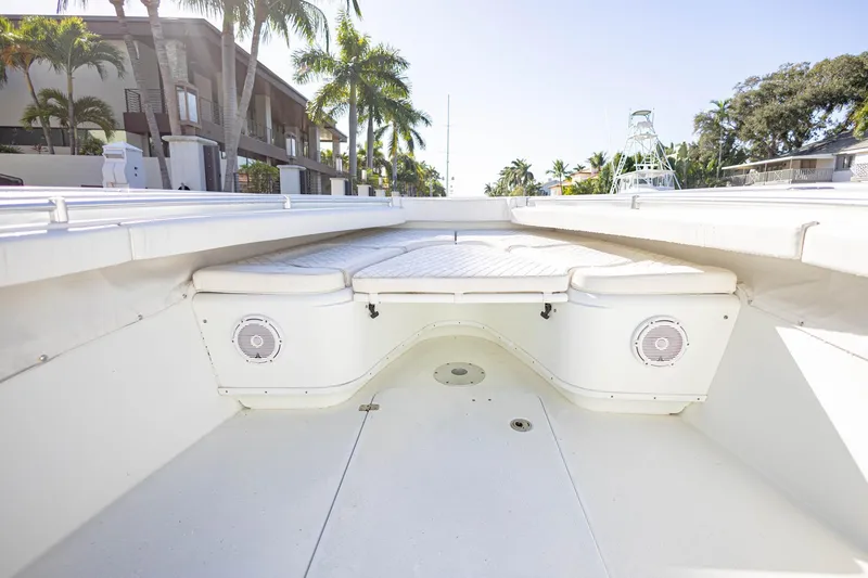 Slide: The Image of 2015 Yellowfin 32 Offshore boat interior with cushioned seating and speakers. - 23