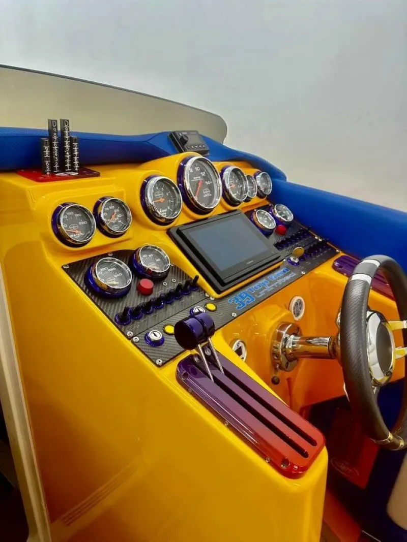 Slide: The Image of Dashboard of a 2005 Cigarette 39 Top Gun boat with vibrant gauges and controls. - 17