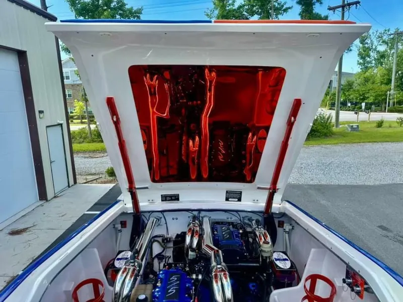 Slide: The Image of 2005 Cigarette 39 Top Gun boat engine compartment with open hatch, showcasing powerful engines. - 20