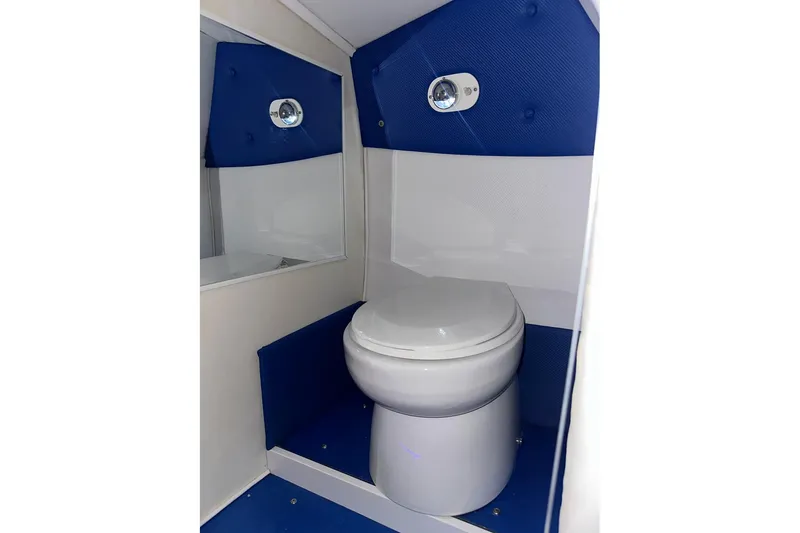 Slide: The Image of 2005 Cigarette 39 Top Gun Unlimited boat bathroom with blue and white interior design. - 28