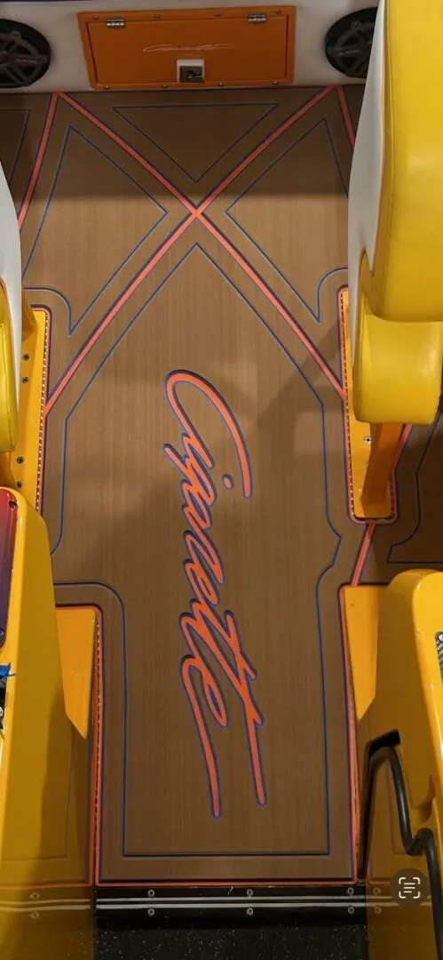 Slide: The Image of 2005 Cigarette 39 Top Gun boat interior with custom flooring and vibrant yellow seating. - 9
